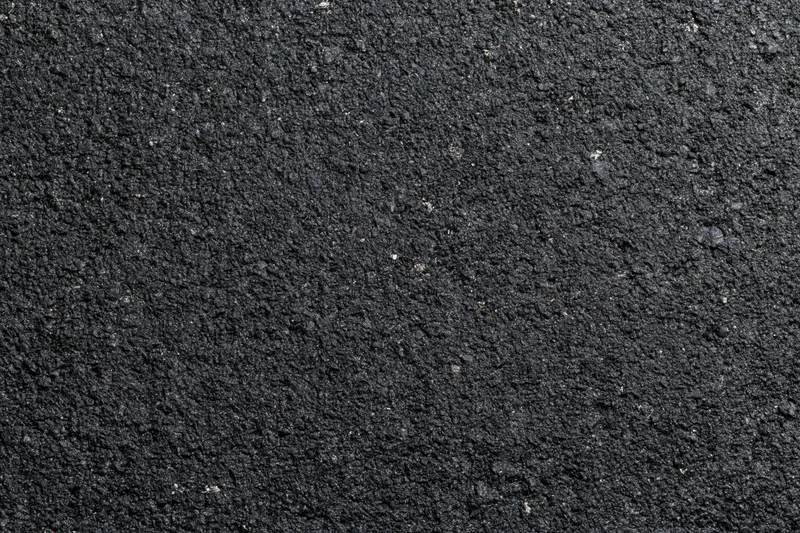 Close-up of dark asphalt surface texture filling the frame