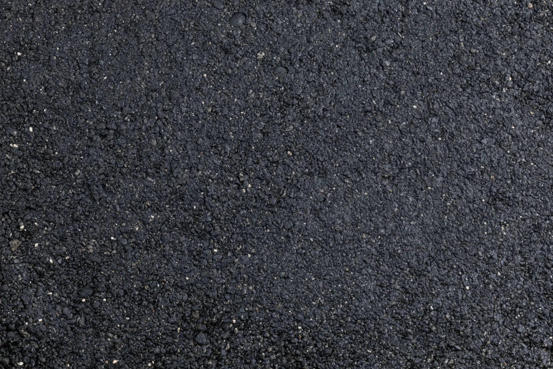 Close-up of dark asphalt surface texture filling the frame