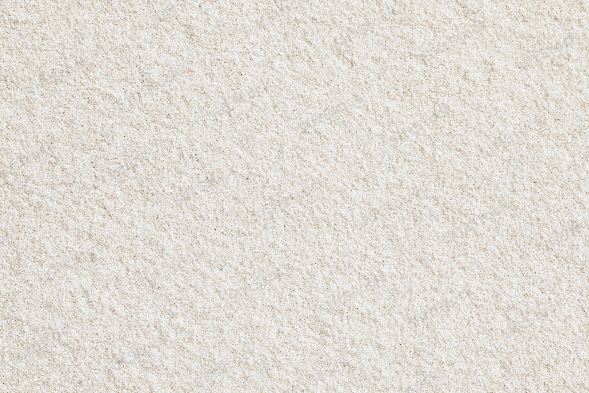 Close-up flat lay of fine dry beach sand filling the entire frame