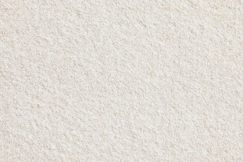 Close-up flat lay of fine dry beach sand filling the entire frame