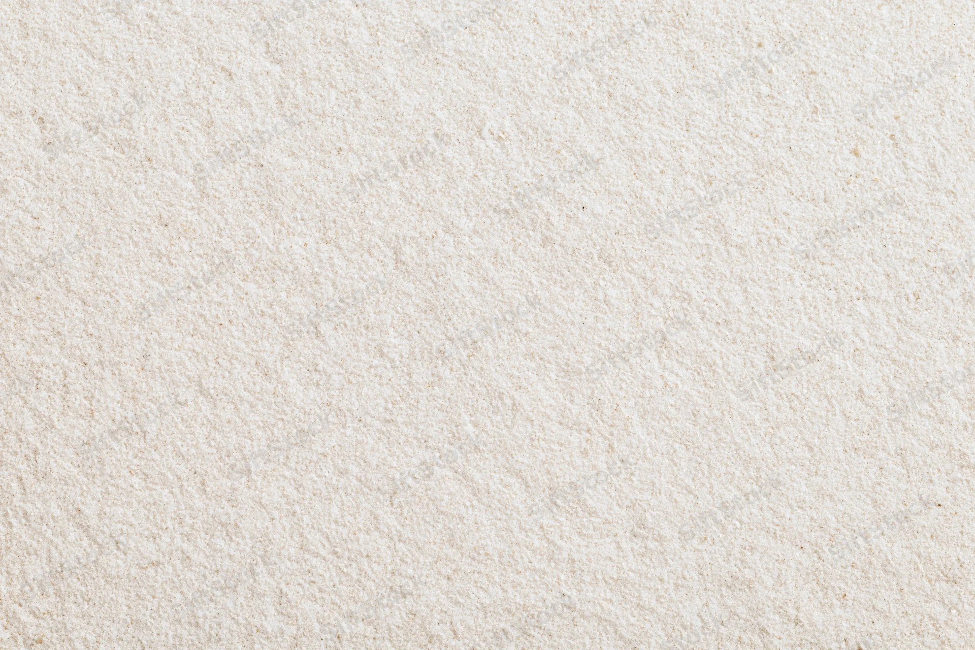 Close-up flat lay of fine dry beach sand filling the entire frame