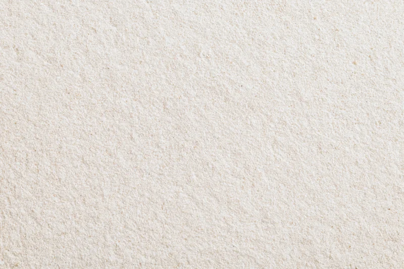Close-up flat lay of fine dry beach sand filling the entire frame