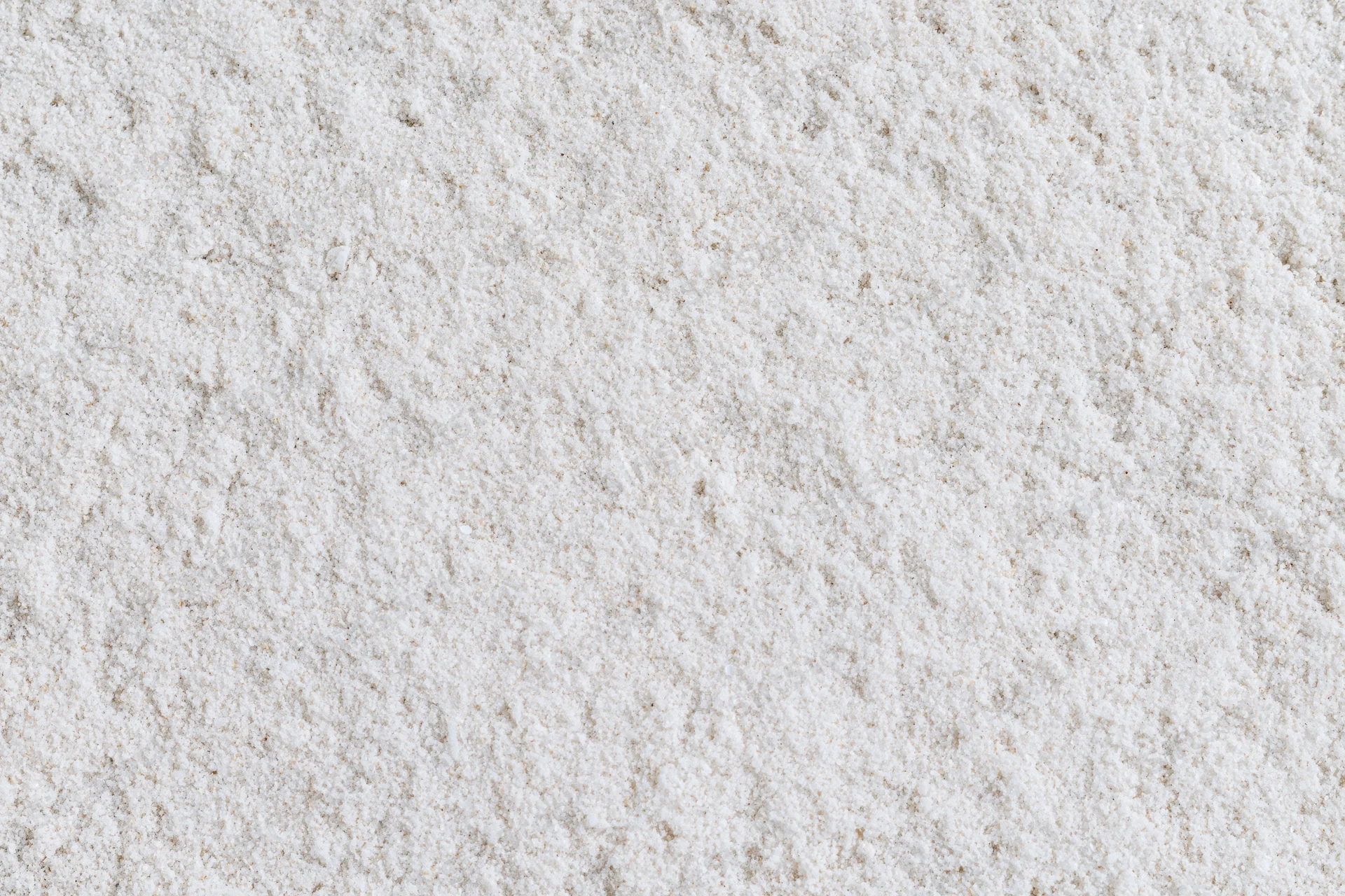 Close-up of fine white sand surface filling the frame