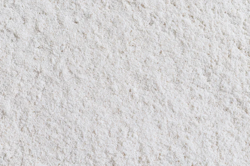 Close-up of fine white sand surface filling the frame