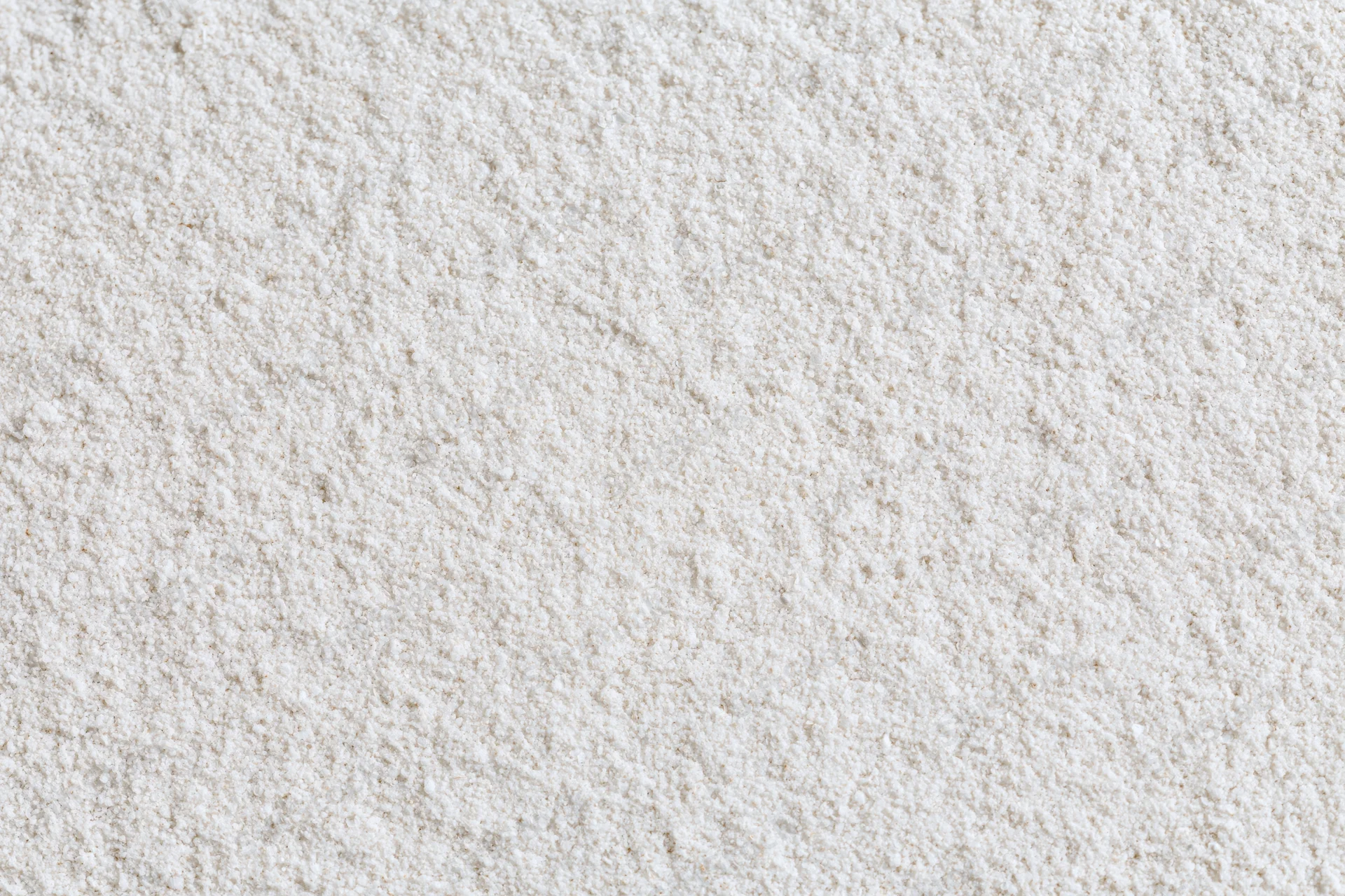 Close-up of fine white sand surface filling the frame