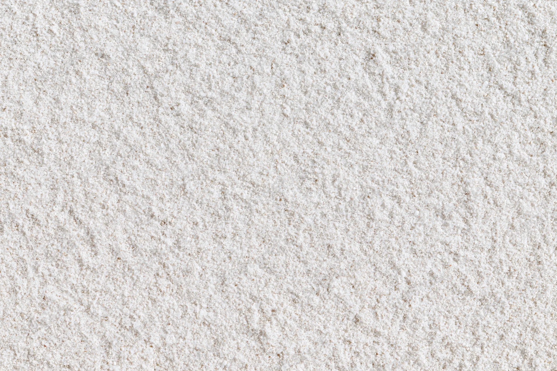 Close-up of fine white sand surface filling the frame