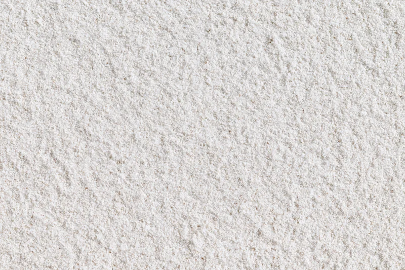 Close-up of fine white sand surface filling the frame