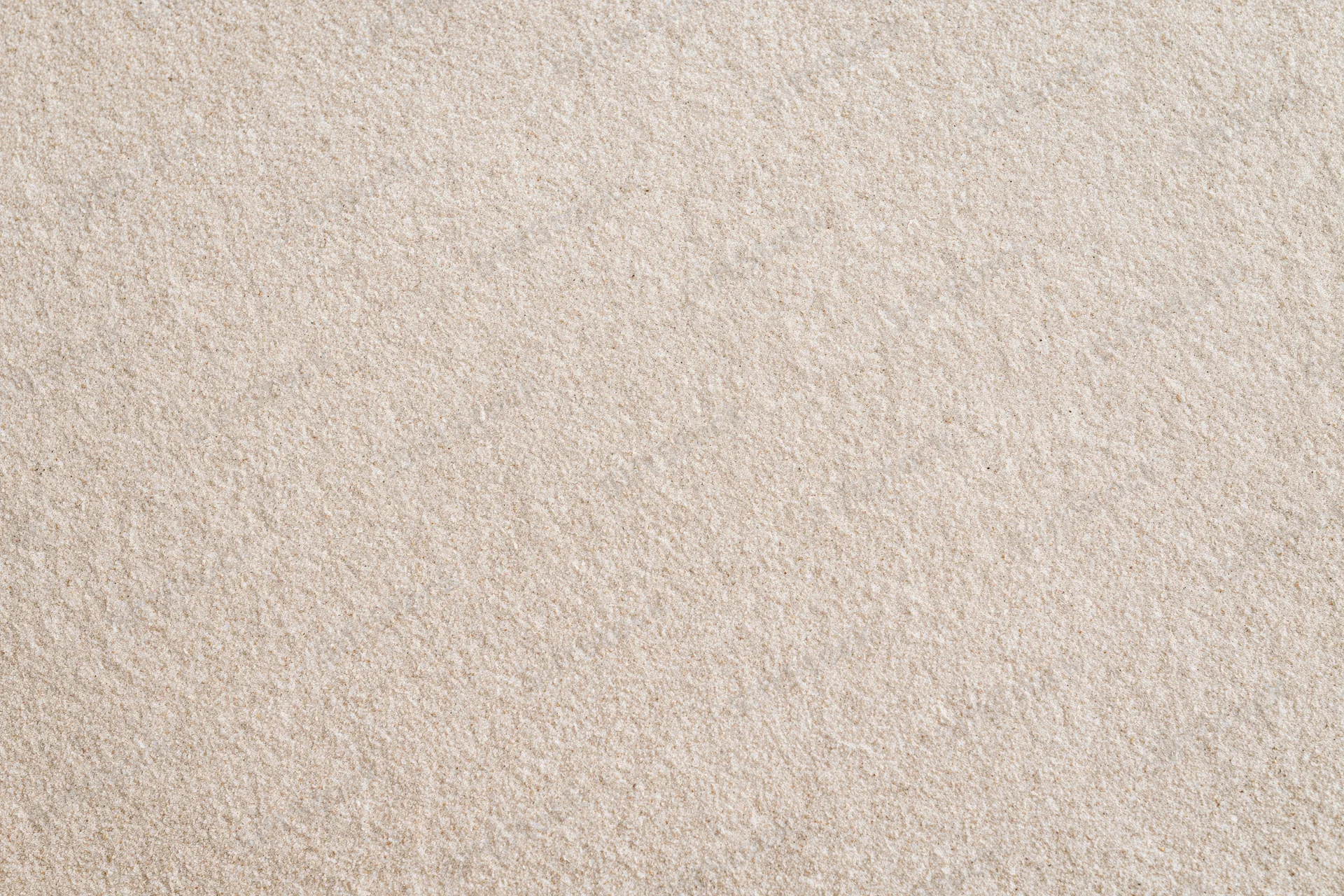 Close-up flat lay of smooth dry beach sand filling the entire frame