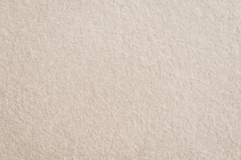 Close-up flat lay of smooth dry beach sand filling the entire frame