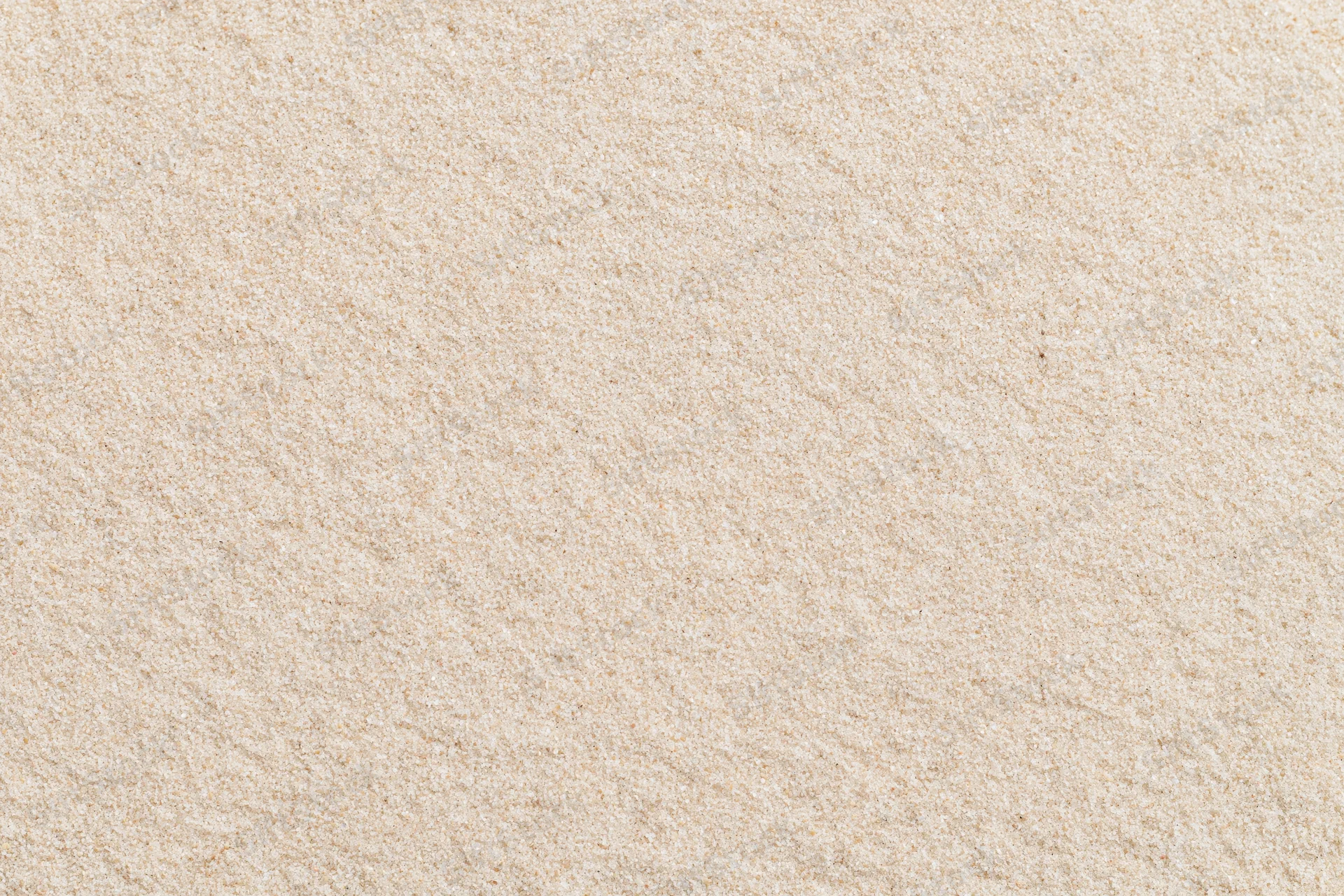 Close-up flat lay of smooth dry beach sand filling the entire frame