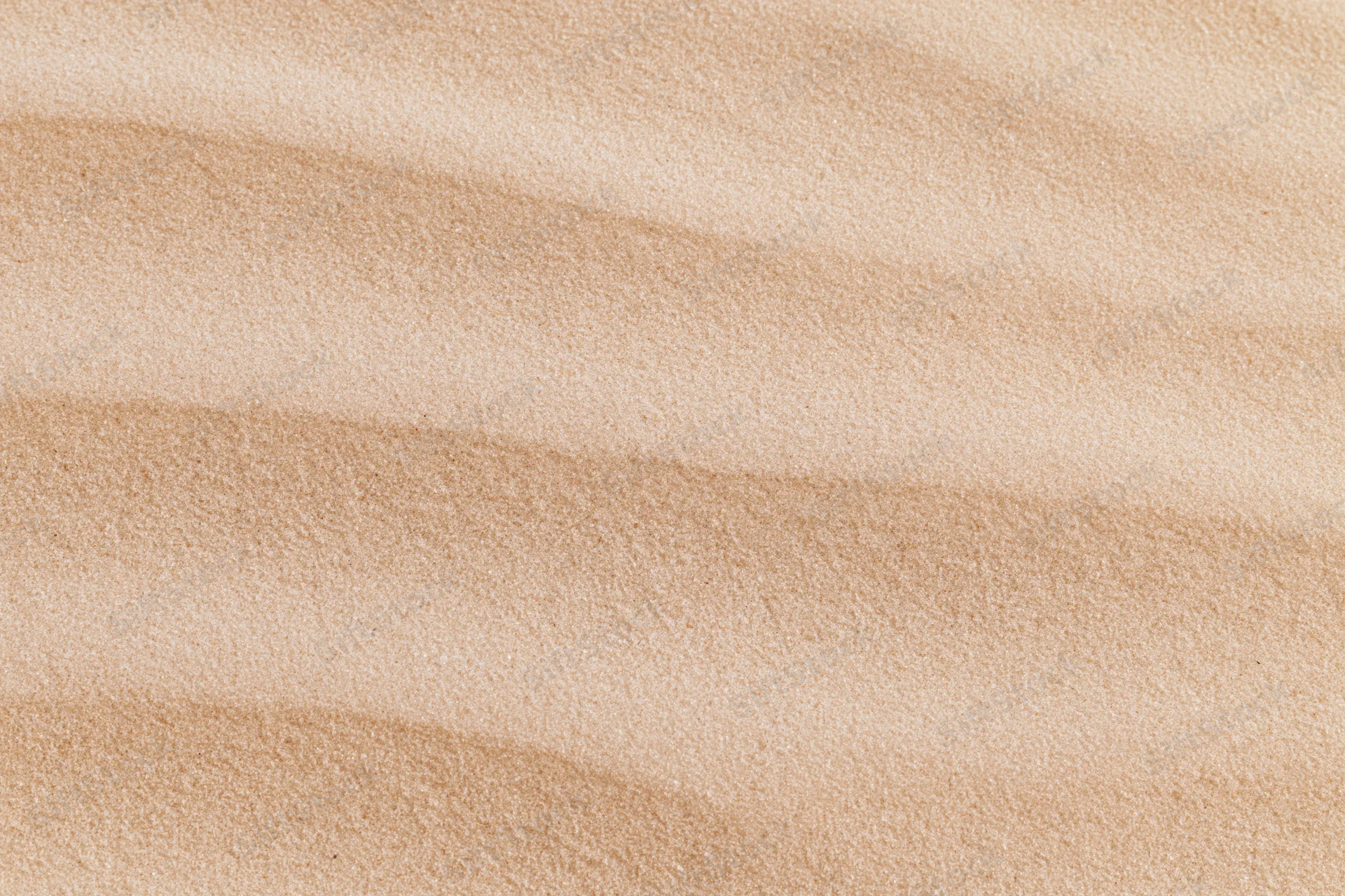 Close-up of smooth dry desert sand surface with rippled texture filling the frame