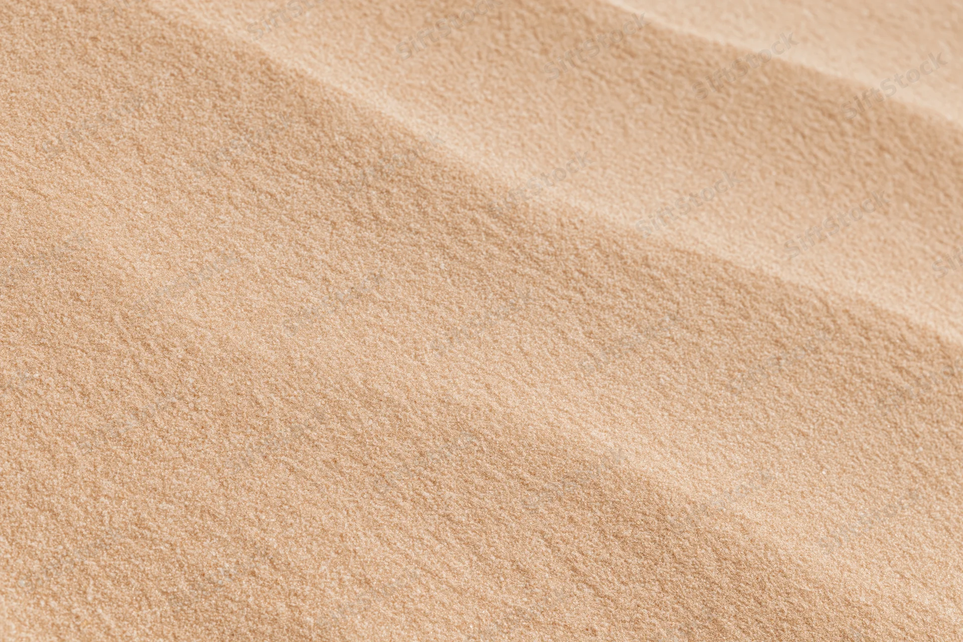 Close-up of smooth dry desert sand surface in flat lay arrangement