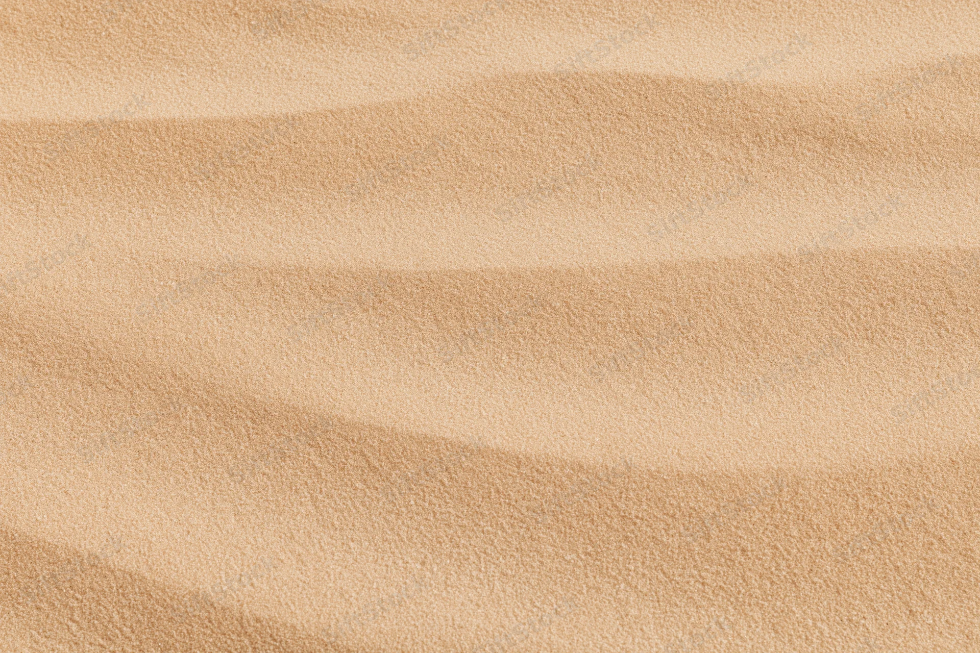 Close-up of smooth dry desert sand surface with rippled texture filling the frame
