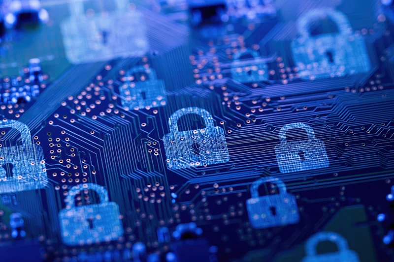 Close-up of a blue circuit board with glowing digital locks symbolizing cybersecurity protection