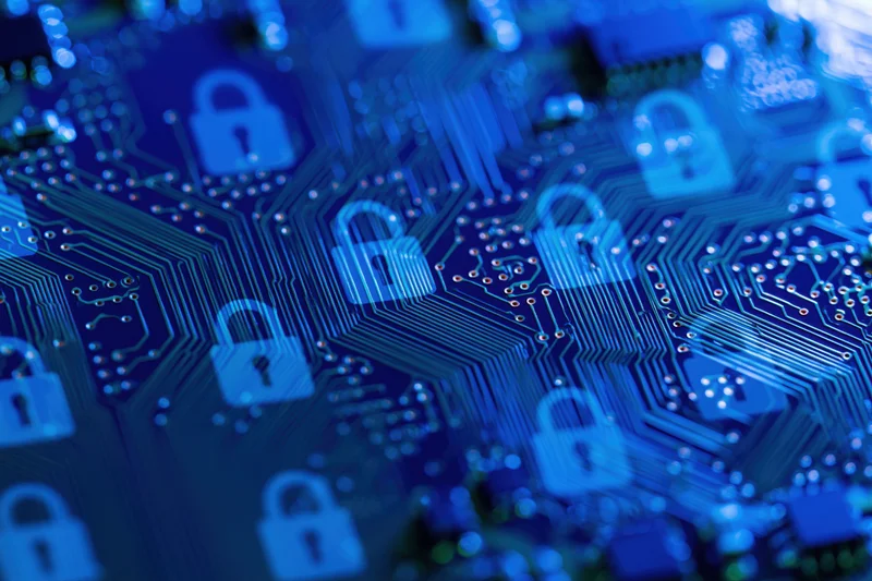 Close-up of a blue circuit board with glowing padlock symbols indicating digital security