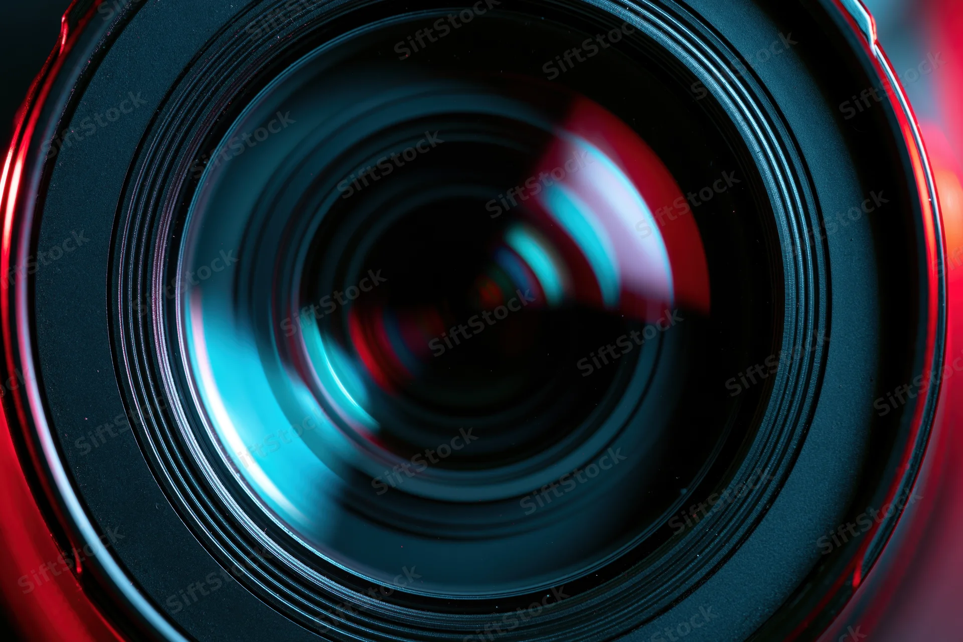 Close-up of a camera lens front element showing reflections and circular glass surface