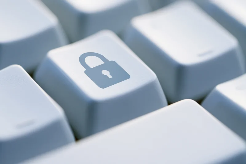 Close-up of a white keyboard key with a lock symbol in focus