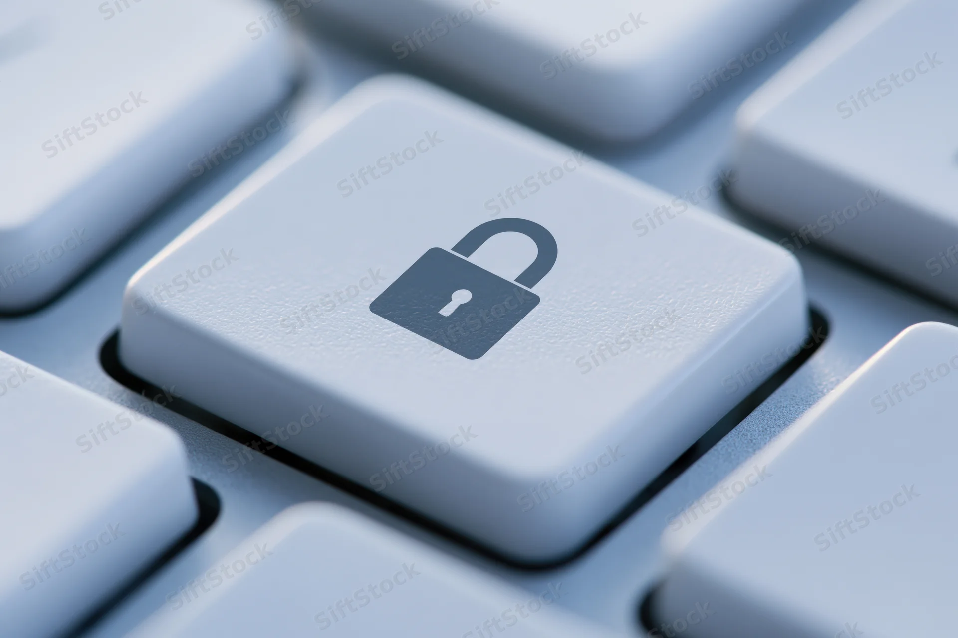 Close-up of a keyboard key with a lock symbol indicating digital security