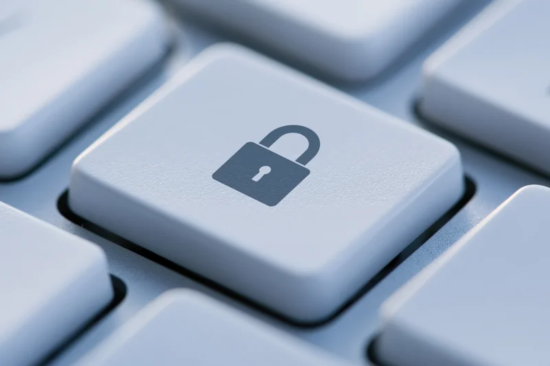 Close-up of a keyboard key with a lock symbol indicating digital security