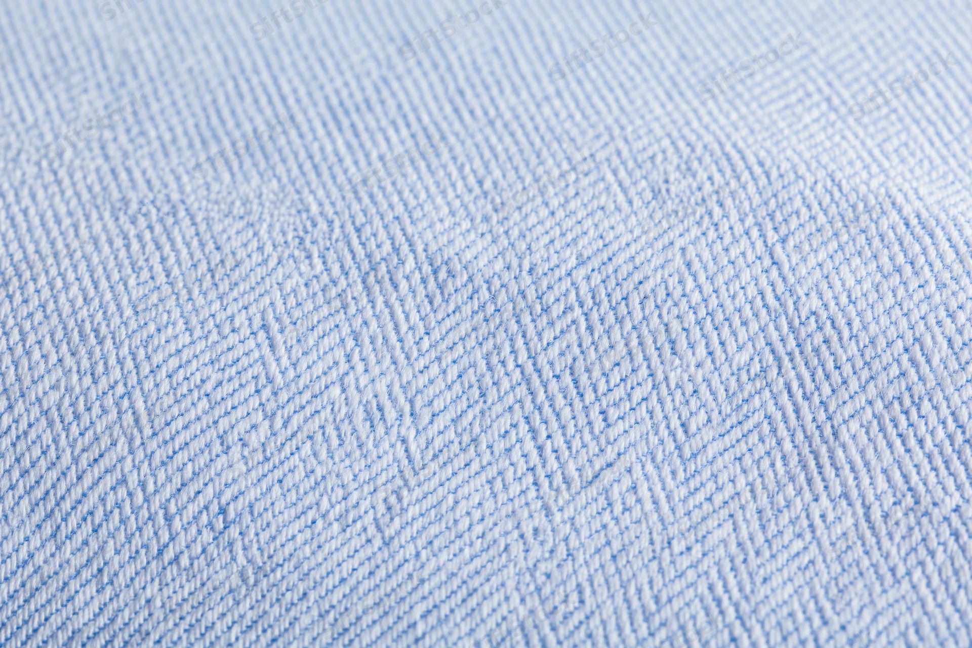 Close-up of light blue and white woven fabric texture from a dress shirt