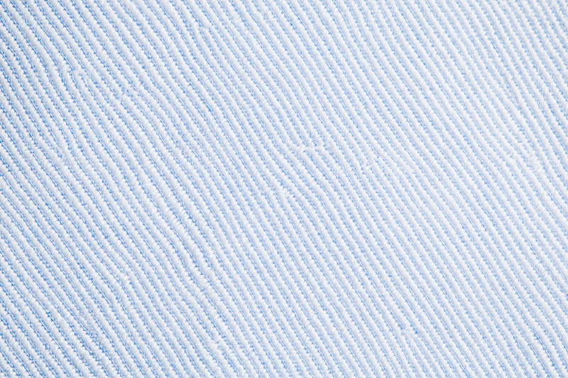 Close-up of light blue and white woven dress shirt fabric