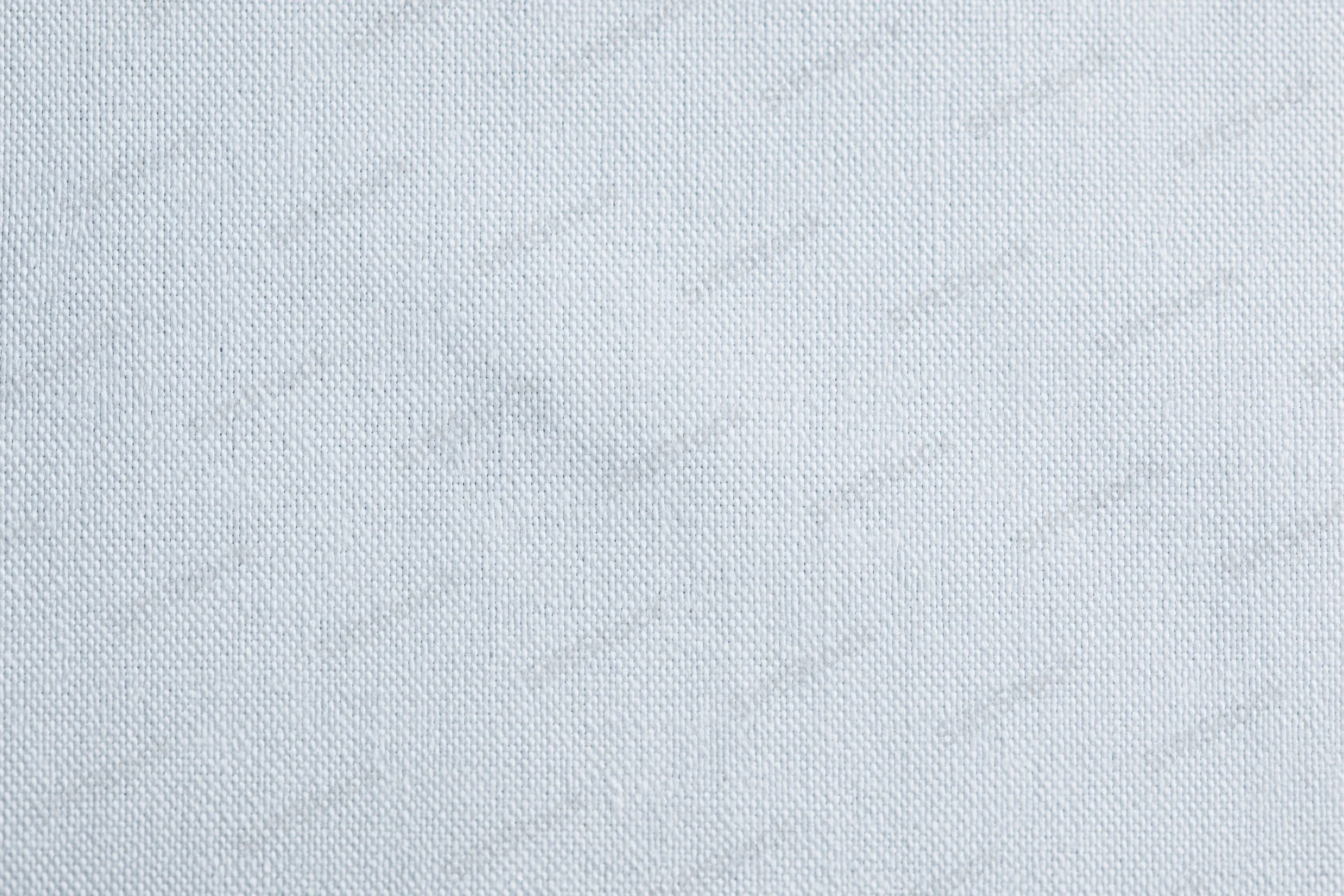 Close-up of plain white woven fabric texture filling the frame