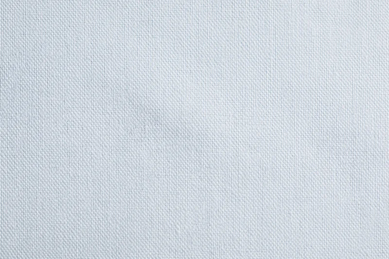 Close-up of plain white woven fabric texture filling the frame