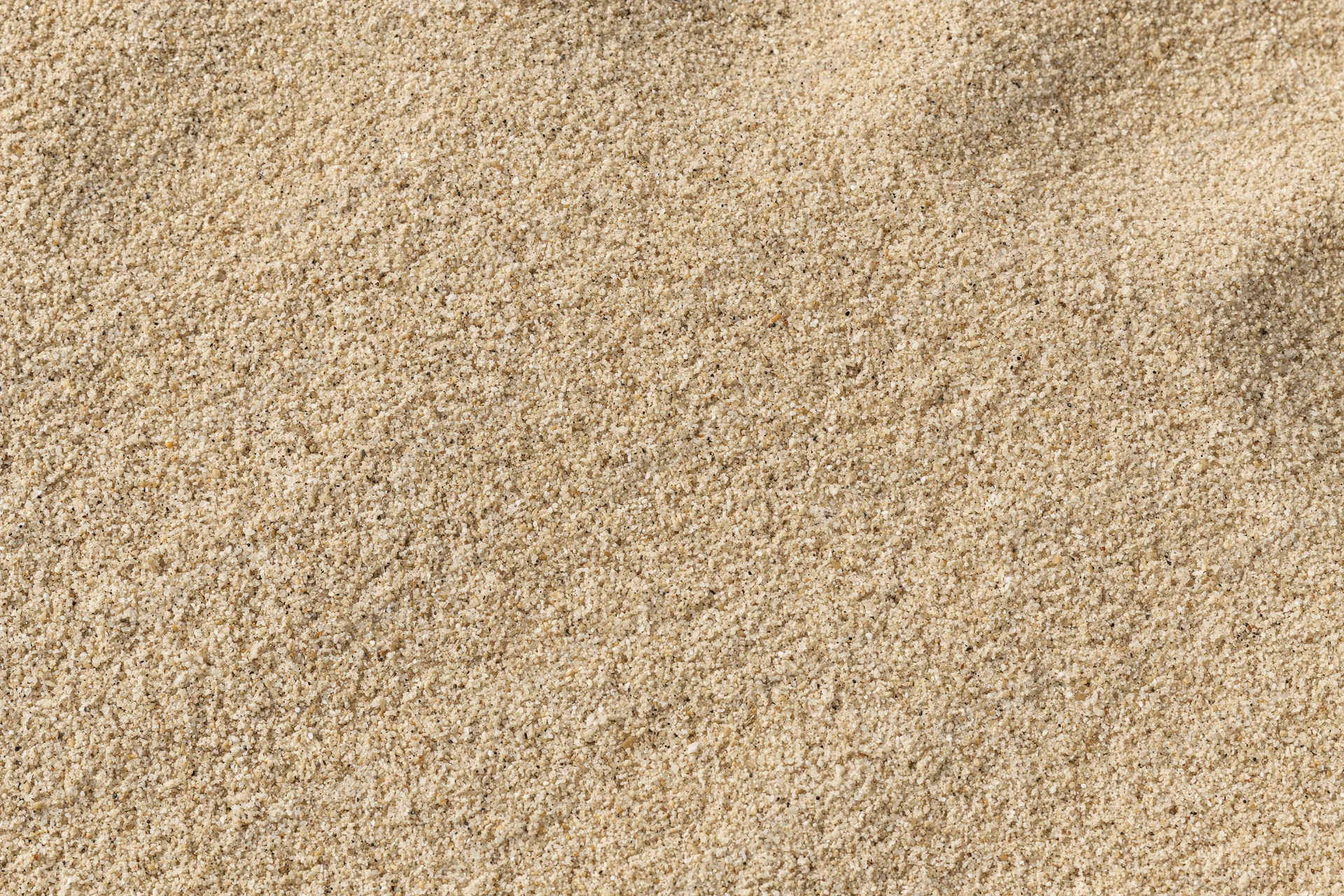 Close-up overhead view of dry beach sand filling the frame