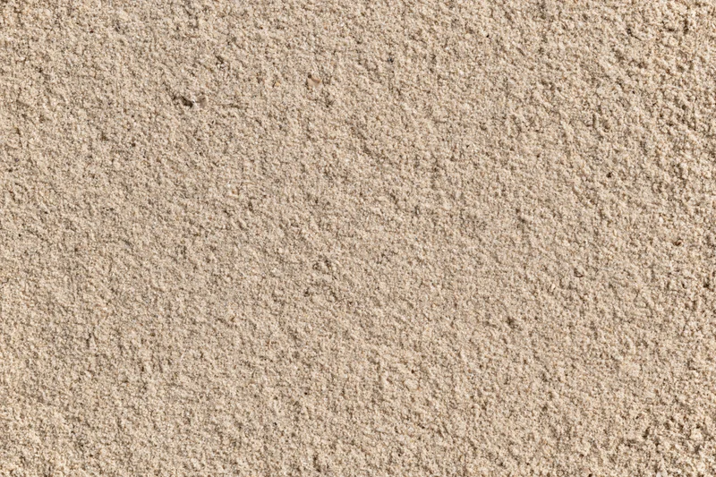 Closeup overhead view of dry beach sand texture filling the frame