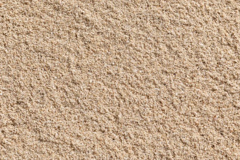 Closeup overhead view of dry beach sand texture filling the frame