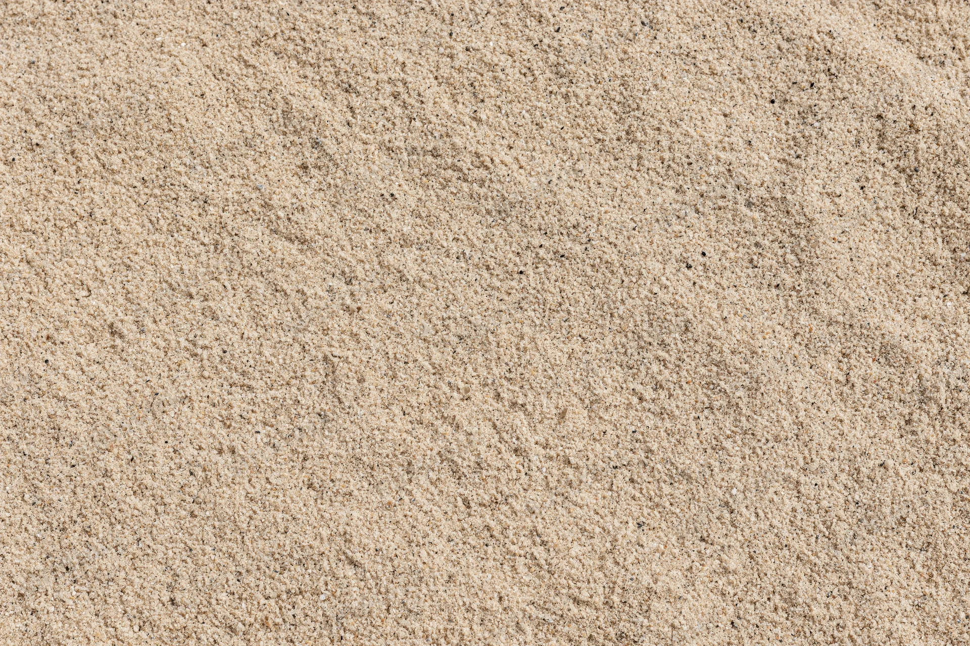 Close-up overhead view of dry beach sand texture filling the frame