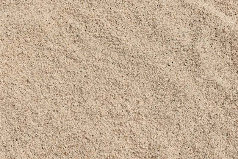 Close-up overhead view of dry beach sand texture filling the frame