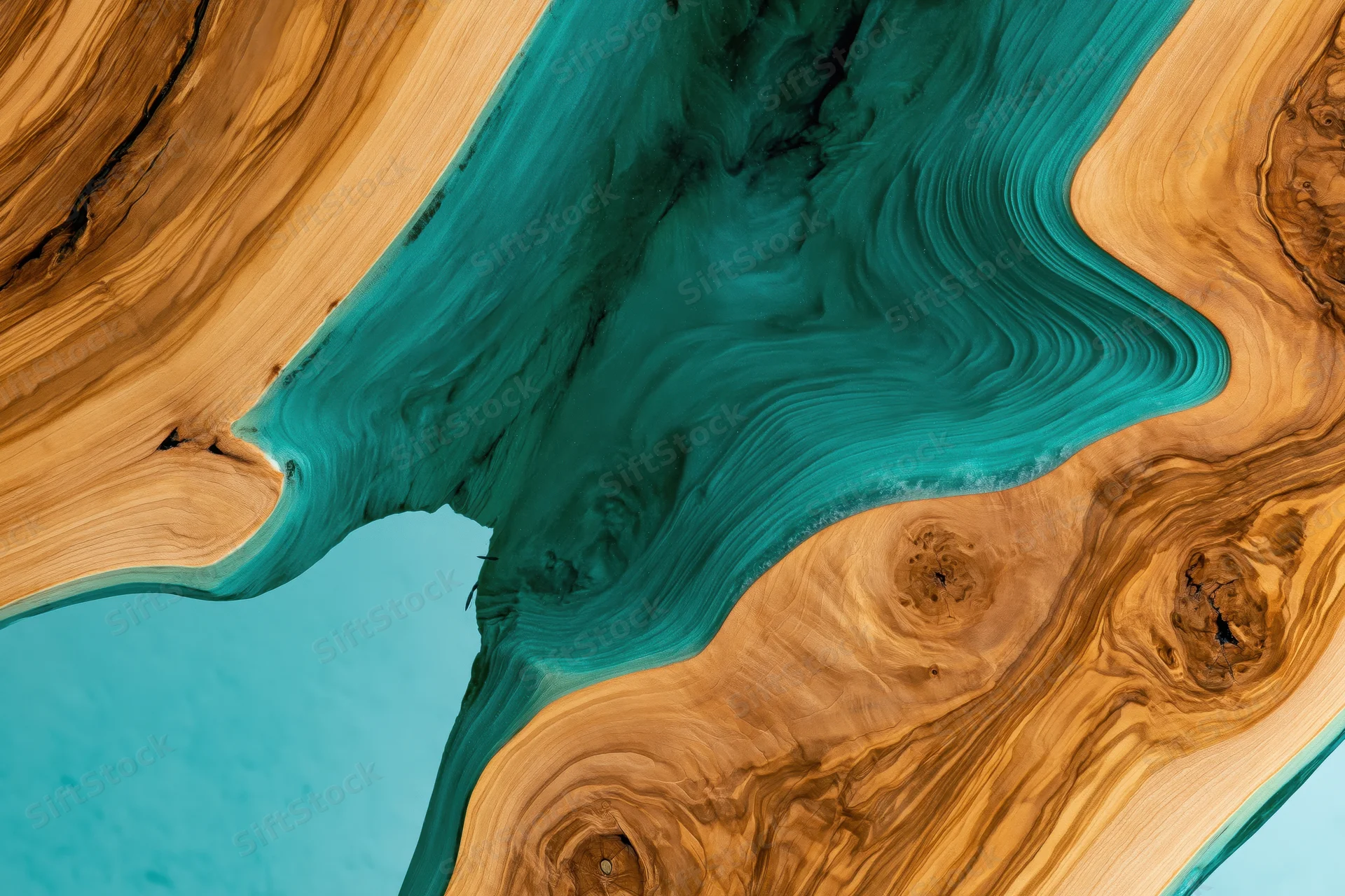 Close-up overhead view of a live-edge epoxy resin river table with natural wood grain and turquoise resin flow