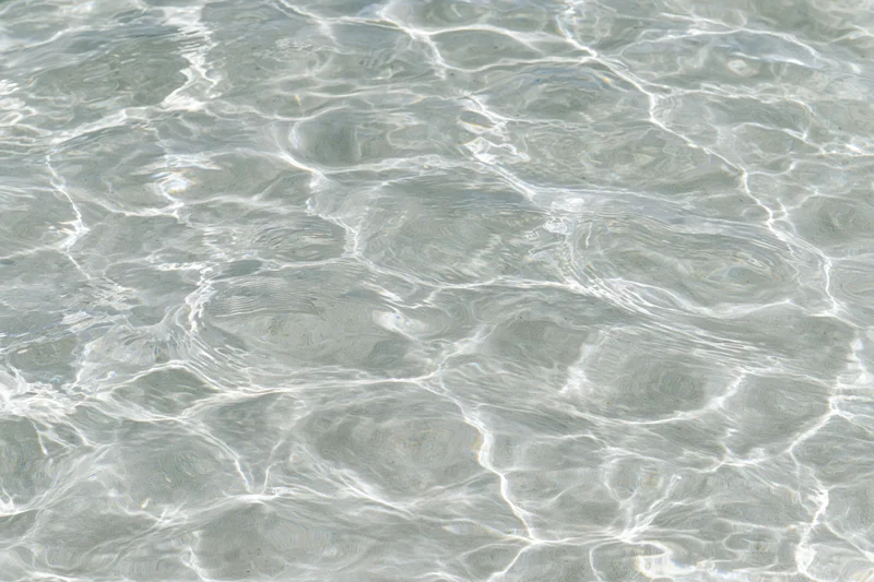 Clear shallow water surface with ripples and light reflections
