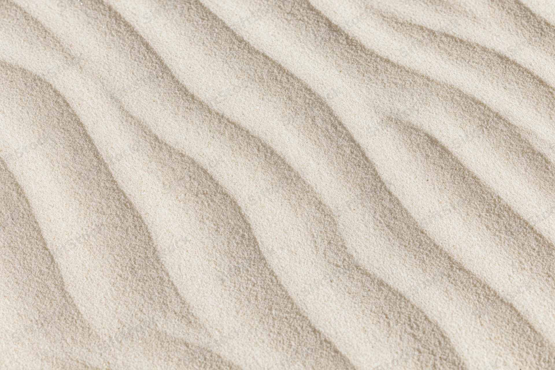 Close-up overhead view of wind-rippled desert sand surface showing natural patterns and texture