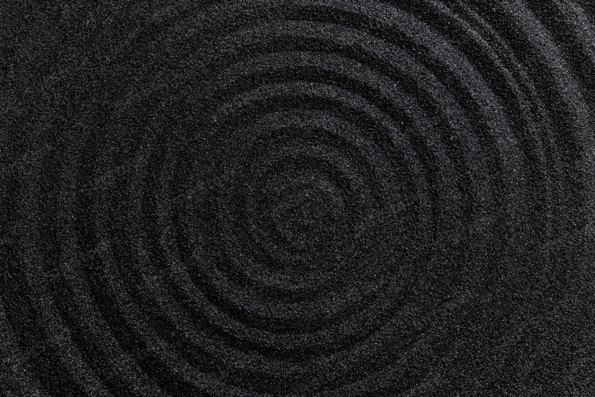 Concentric circles raked into dark black volcanic sand center