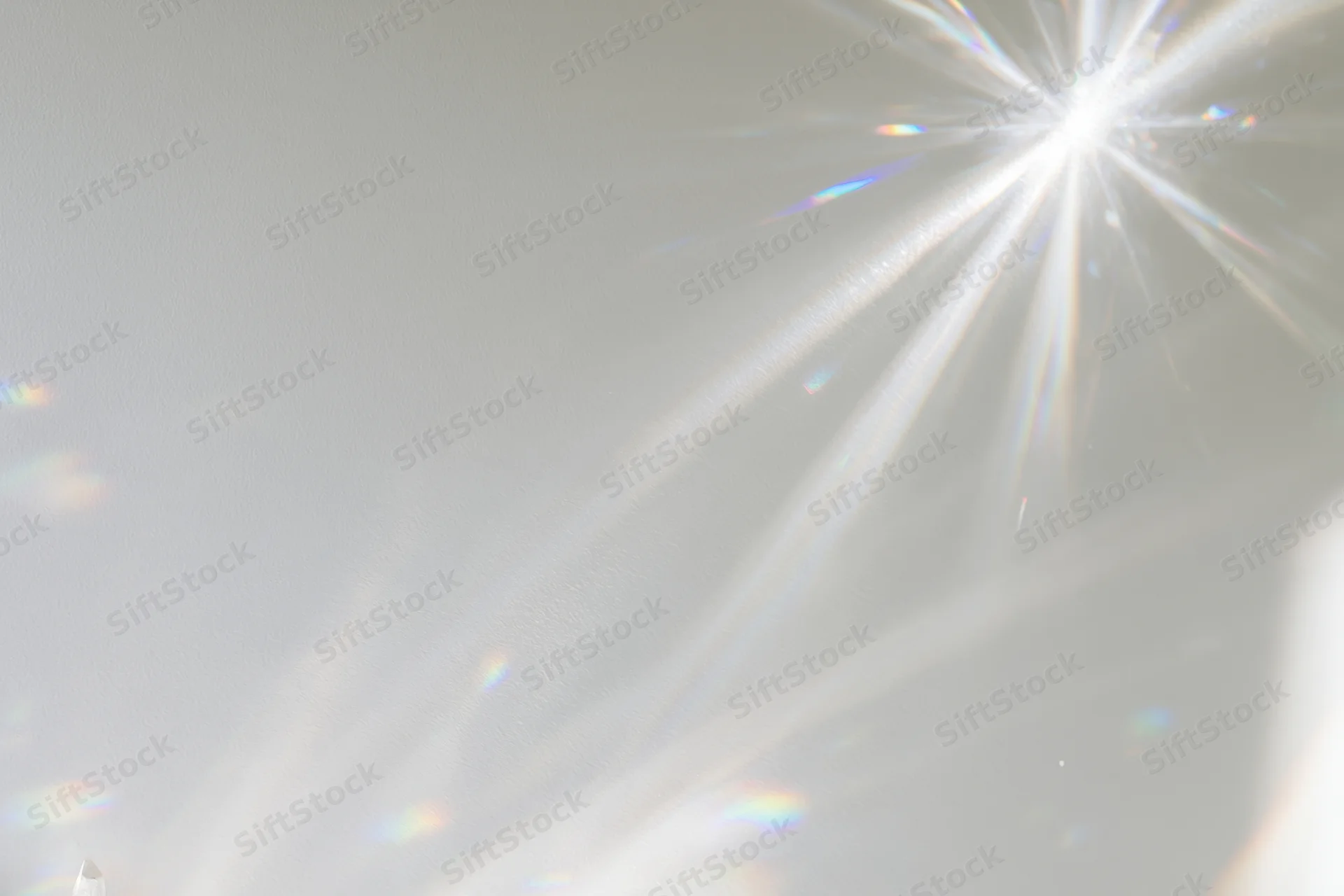 Crystal light refraction patterns cast across a plain matte surface