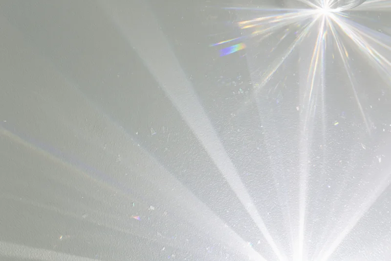 Crystal light refraction patterns cast across a plain matte surface