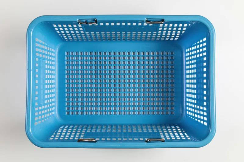 Empty blue plastic shopping basket viewed from directly above on white background