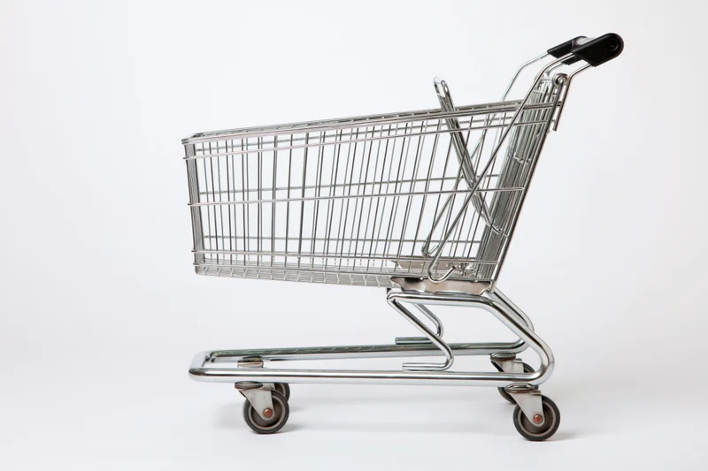 Empty chrome shopping cart side profile on white background