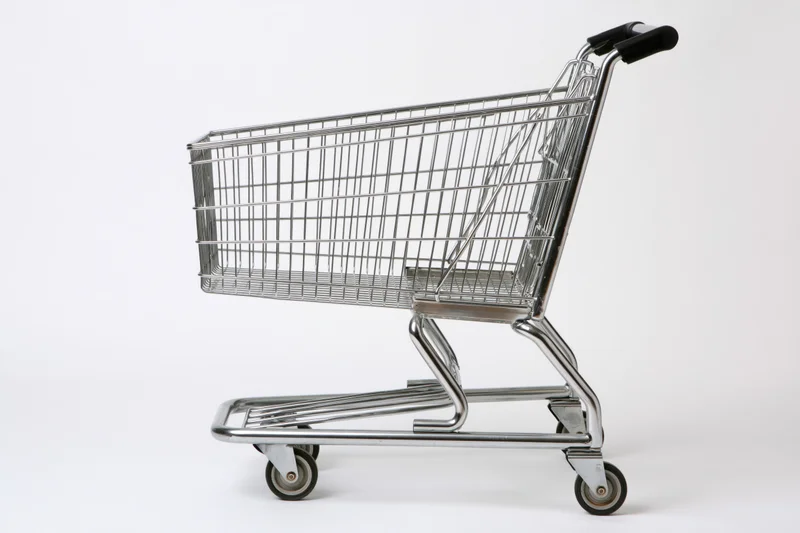 Empty chrome shopping cart side profile on white background