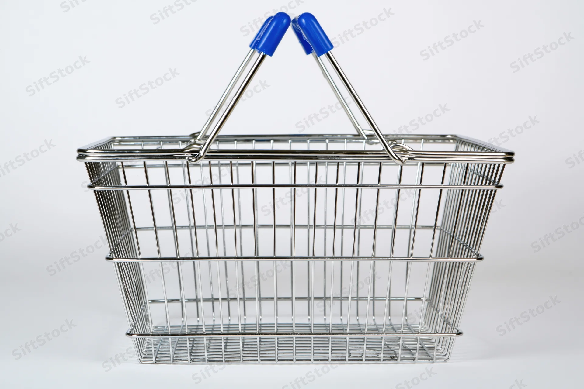 Empty chrome wire shopping basket with raised blue-handled grips isolated on white background