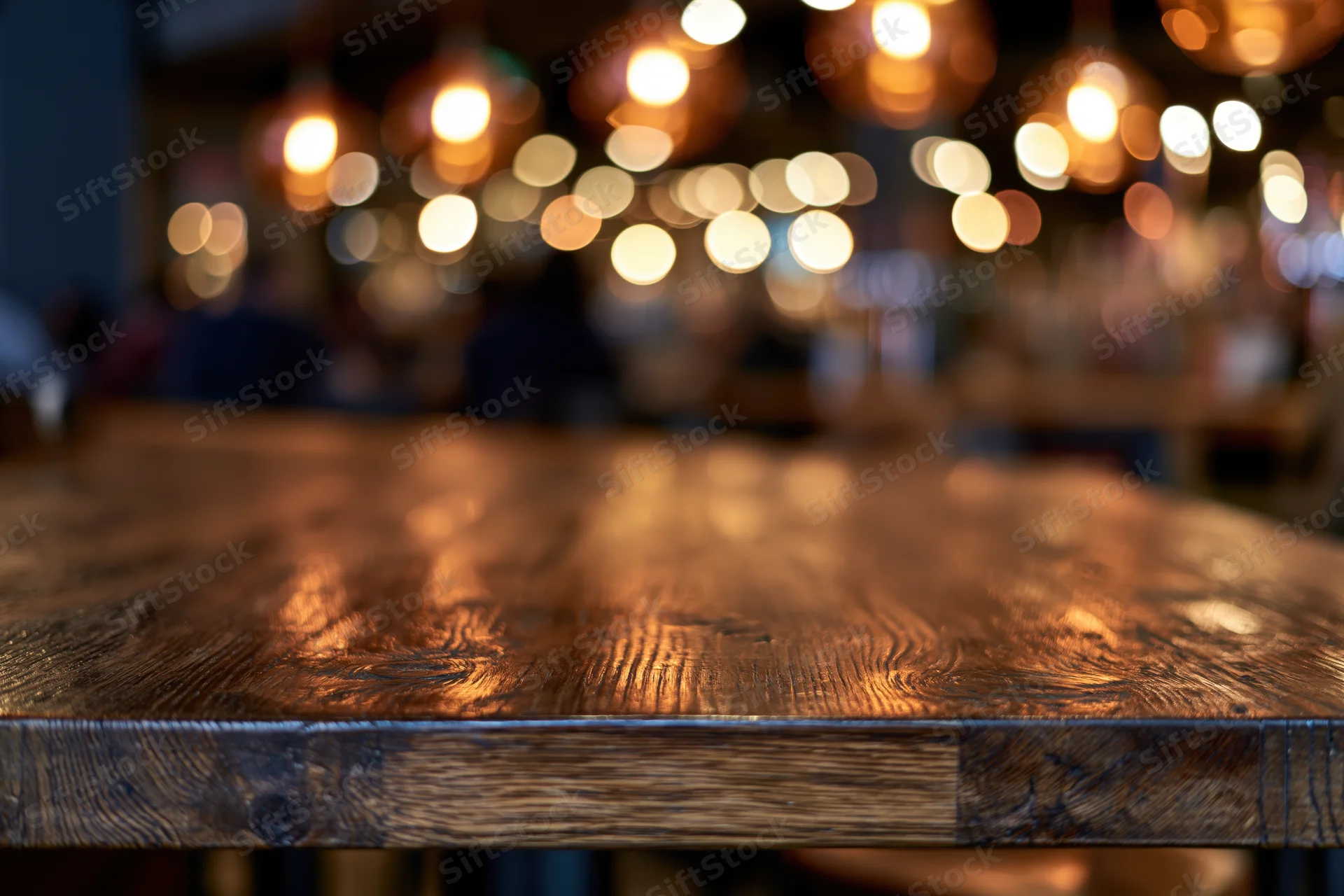Dark wooden bar counter in sharp focus with blurred restaurant interior and warm bokeh lights in background