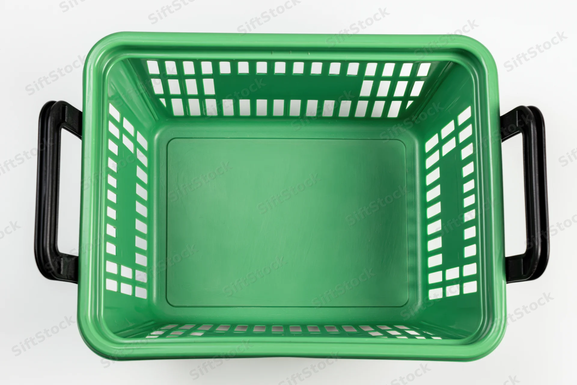 Empty green plastic shopping basket viewed from above on white background