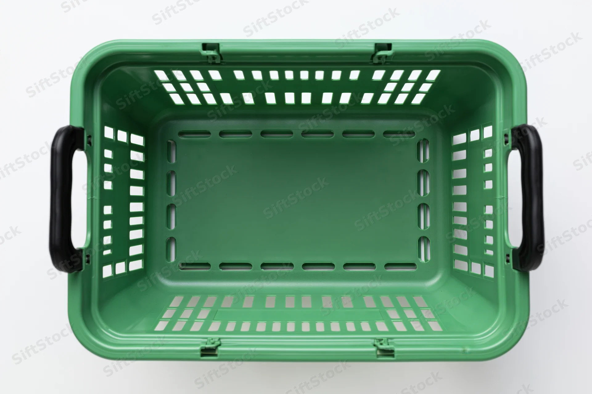 Empty green plastic shopping basket viewed from directly above on white background