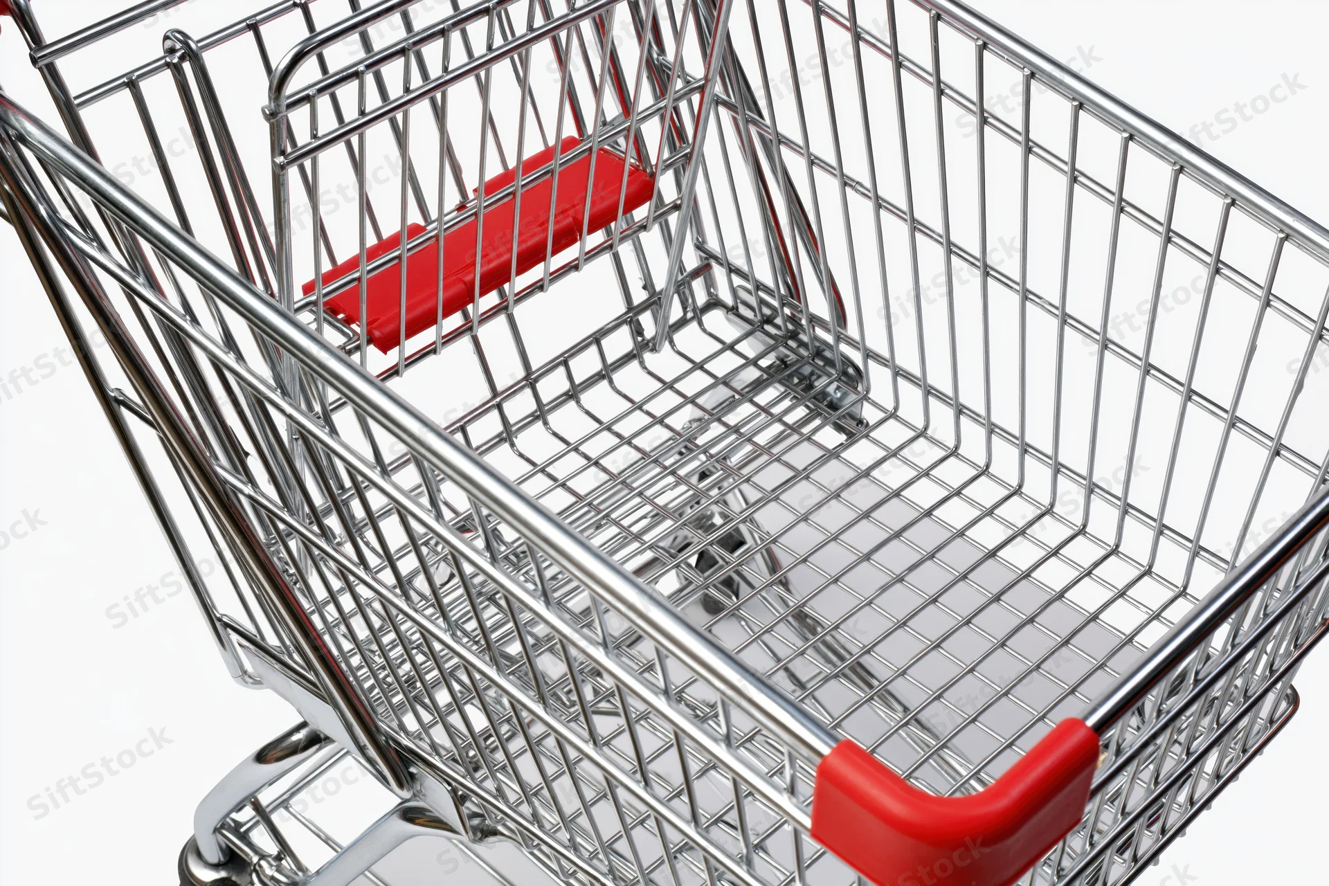 Empty metal shopping cart viewed from above on white background