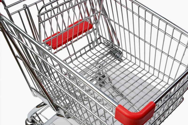 Empty metal shopping cart viewed from above on white background