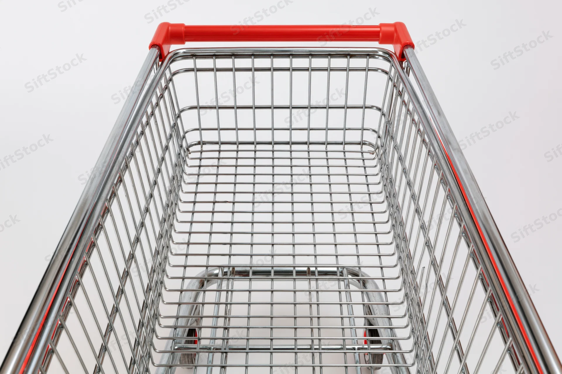 Empty metal shopping cart viewed from above against white background