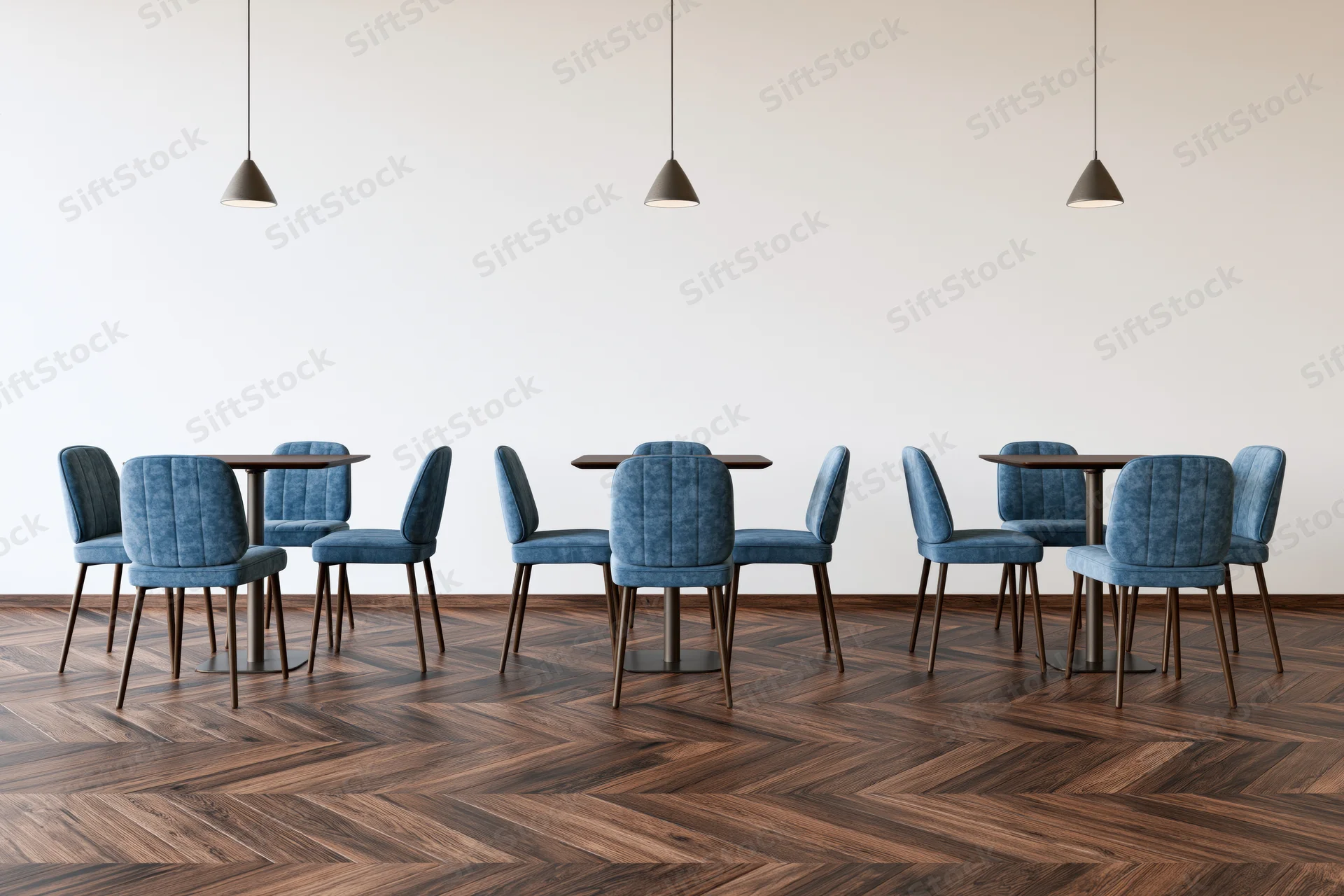 Modern cafe interior with small square tables and blue upholstered chairs arranged on herringbone wood flooring