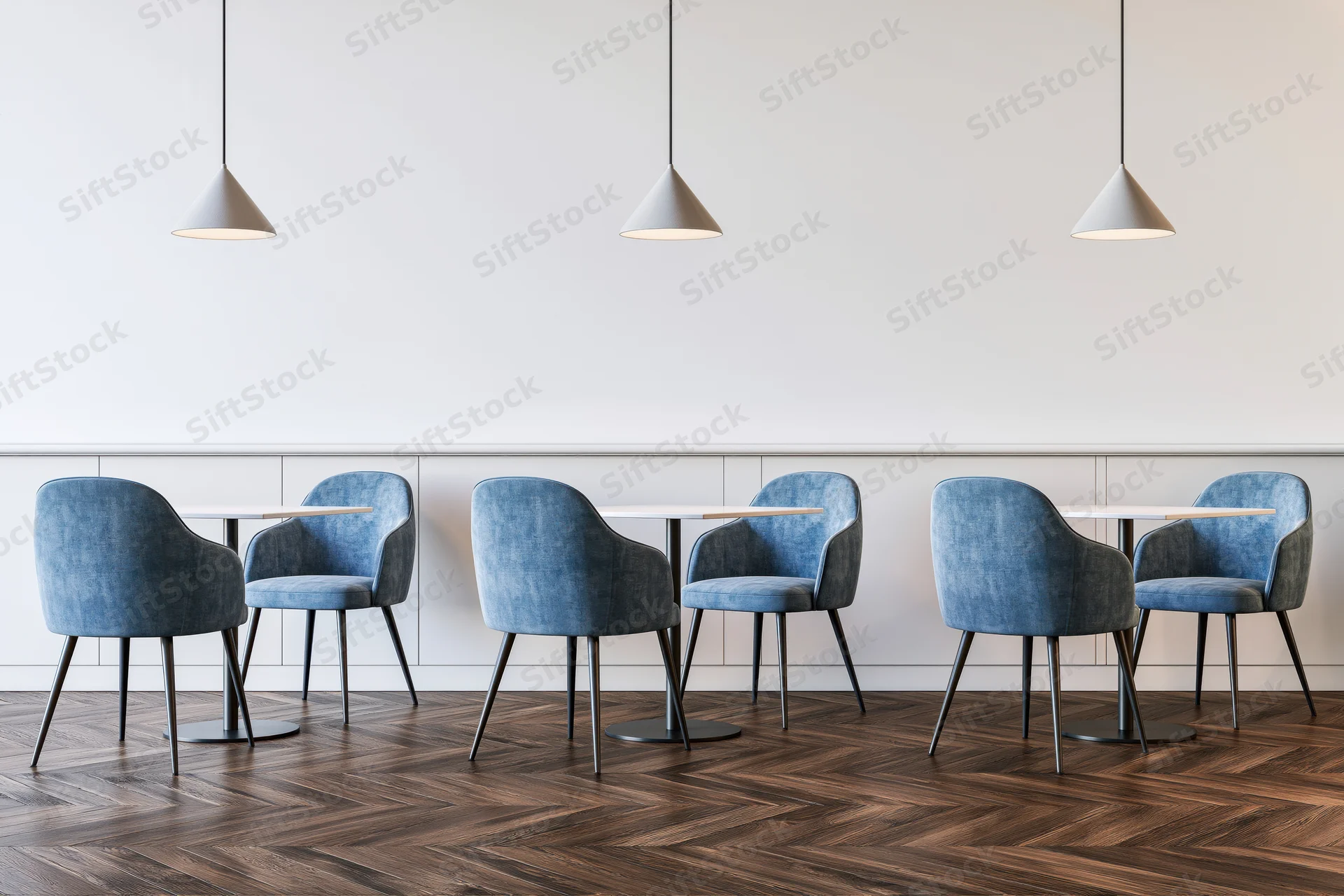 Modern cafe interior with blue chairs and small tables arranged in rows under pendant lights on a wooden herringbone floor